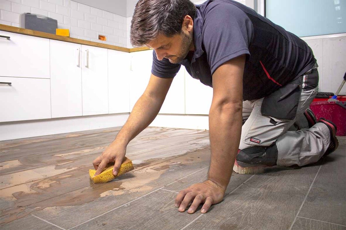 Grout Master cleaning and preparing grout